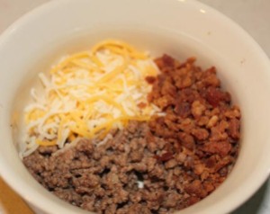 Brown the hamburger and drain, then mix with bacon and cheese.
